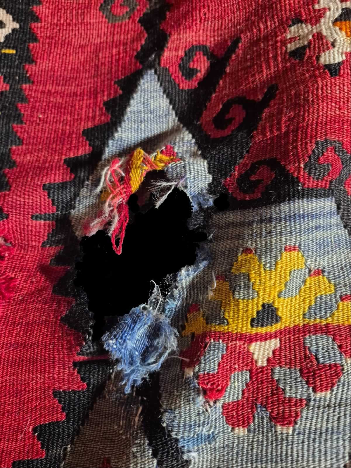 Kilim with medium size hole before repair / restoration